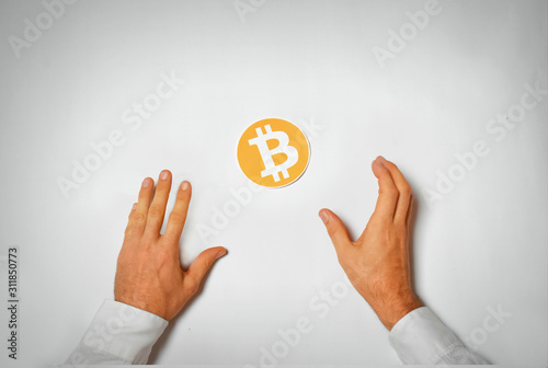 Arms reaching for Bitcoin symbol photo