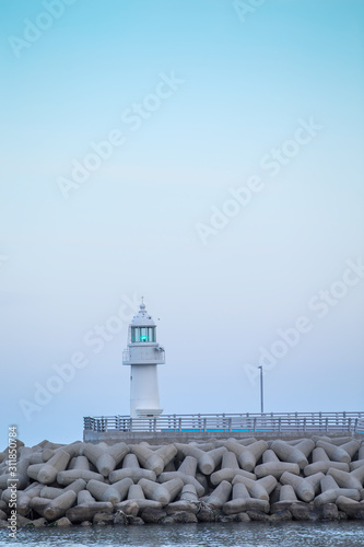 lighthouse. A lighthouse on the coast. A lighthouse on a breakwater. Lighthouse and Tetrapod.