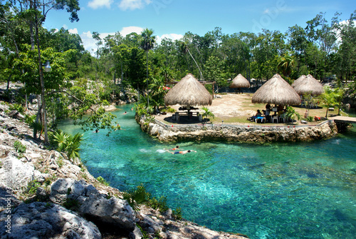 Cenote with crystal clear blue waters near Tulum Mexico photo