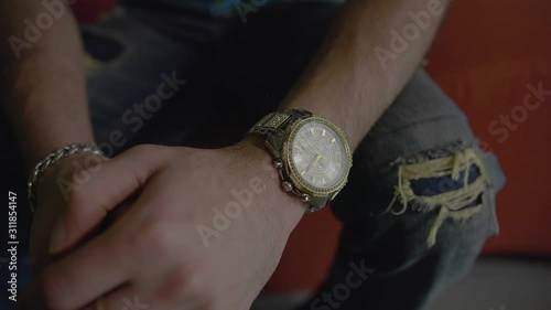 slow motion parallax shot of a gold wrist watch. photo