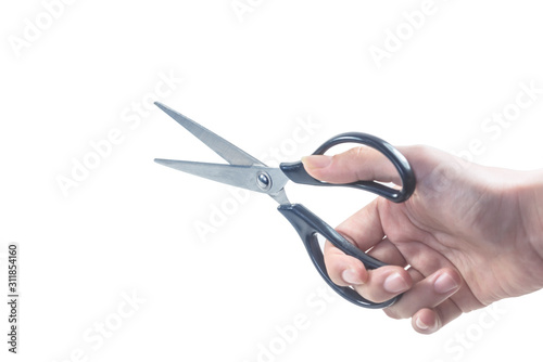 The close-up holds an open pair of scissors.