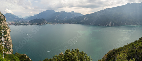 Drone aerial view of Lake Garda from the hills surrounding it. Summer time. Famous tourist destination. It is the biggest lake in Italy