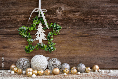 Christmas star with christmas balls on a wooden background. Christmas or New Year greeting card.