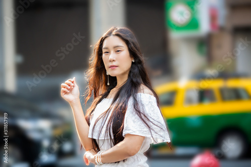 Portrait of cool young asian woman or Happy calm Chinese woman with asian character face and fashionable on white dress