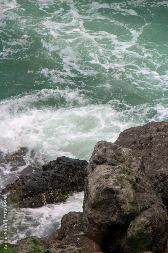 sea water and small waves that hit rocks on the beach sea water and small waves that hit rocks on the beach