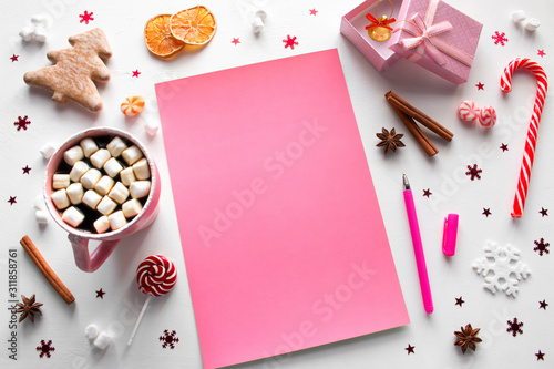 christmas sweets, decorations and pink new year's wishlist with place for text mockup