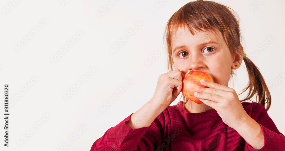 Close up portrait of a cute child girl bites apple as symbol of diet and healthy food. Close up portrait of a cute child girl bites apple as symbol of diet and healthy food.