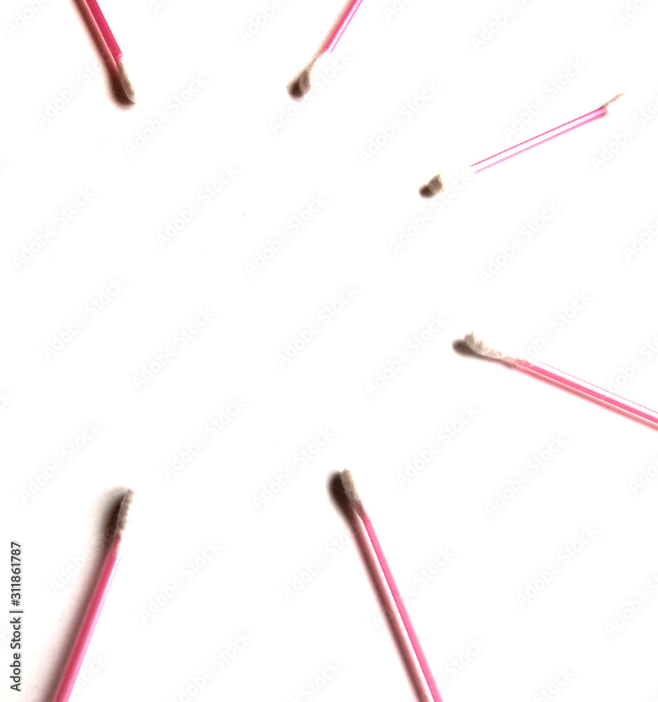 Pink Cotton swabs on a white isolated background. Copy space. View from above. Ear sticks. Pink Cotton swabs on a white isolated background. Copy space. View from above. Ear sticks.