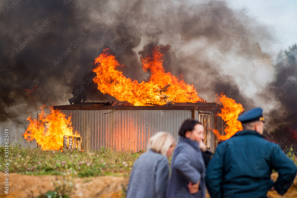 A building in fire. Training fire service to extinguish a fire, civil defense exercises