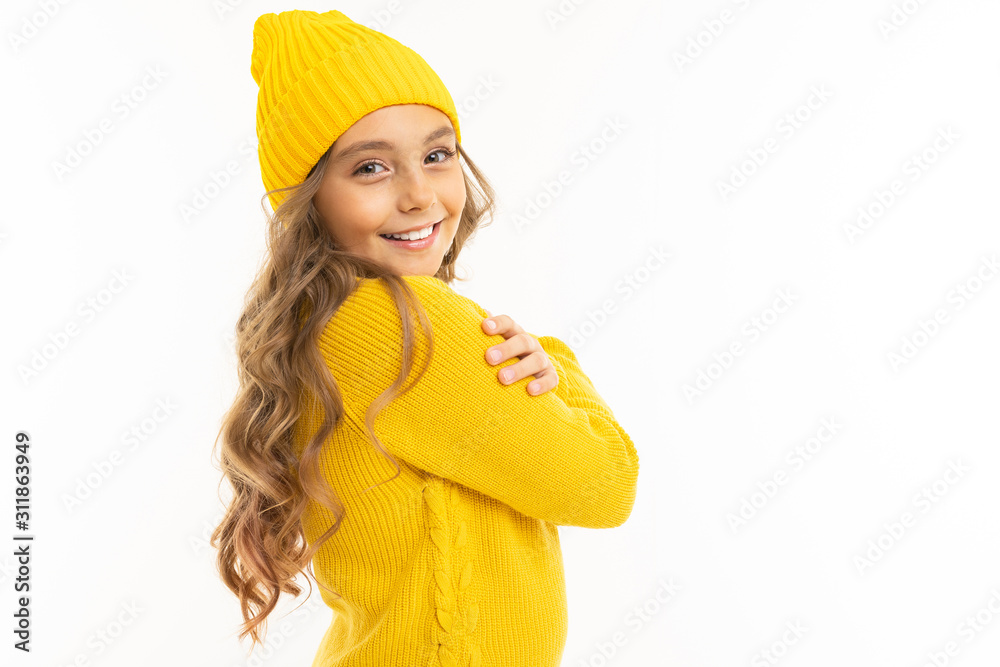 Little girl with in yellow hoody and hat enjoying, portrait isolated on white background Little girl with in yellow hoody and hat enjoying, portrait isolated on white background