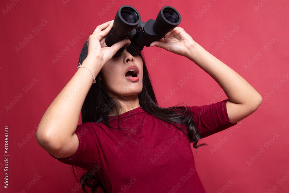 Young Asian woman with binoculars. Young Asian woman with binoculars.