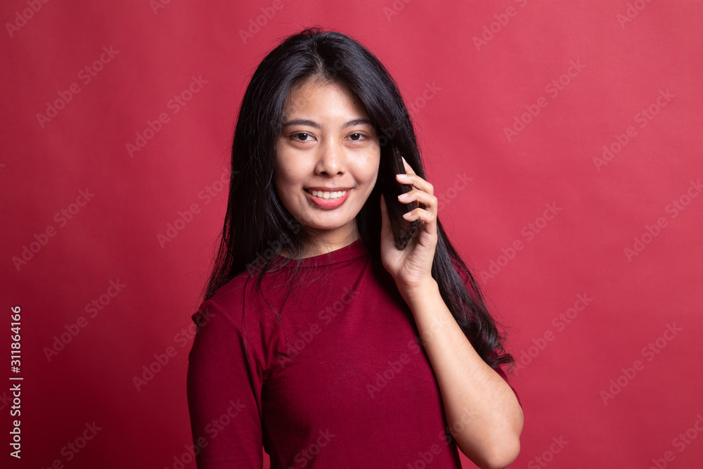 Young Asian woman talking with mobile phone. Young Asian woman talking with mobile phone.