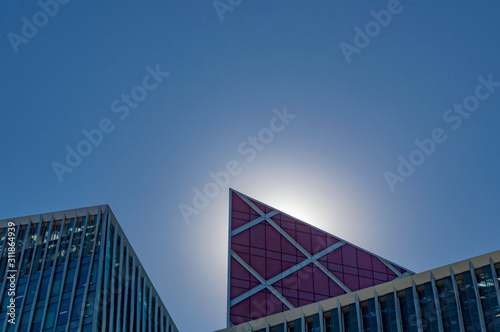 Sun behind office building facade details