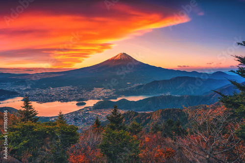 Landscape image of Mt. Fuji over Lake Kawaguchiko with autumn foliage at sunrise in Fujikawaguchiko, Japan.
