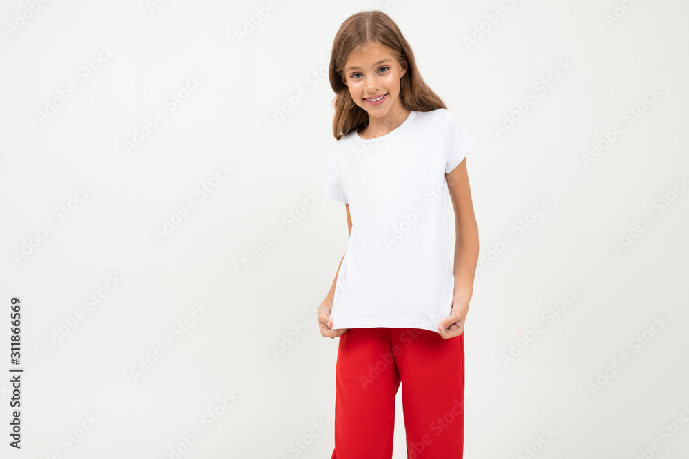 Teenager caucasian girl in black jacket, white shirt and red pants smiles isolated on white background Teenager caucasian girl in black jacket, white shirt and red pants smiles isolated on white background