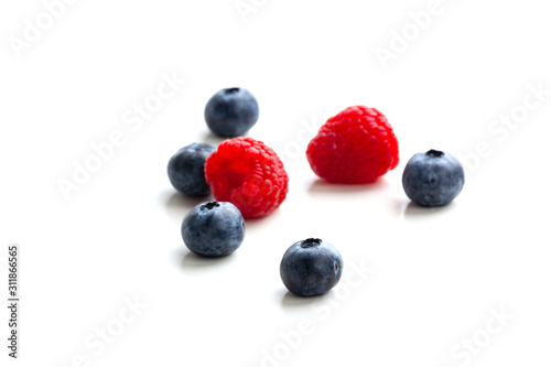 blueberries and raspberries isolated on white