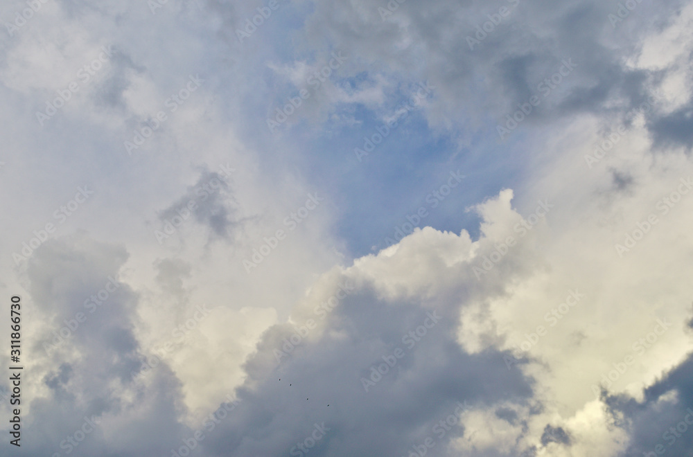 Blue sky and fluffy clouds. Beautiful cloudscape background. Sunlight on the clouds. Blue gradient. Blue sky and fluffy clouds. Beautiful cloudscape background. Sunlight on the clouds. Blue gradient.