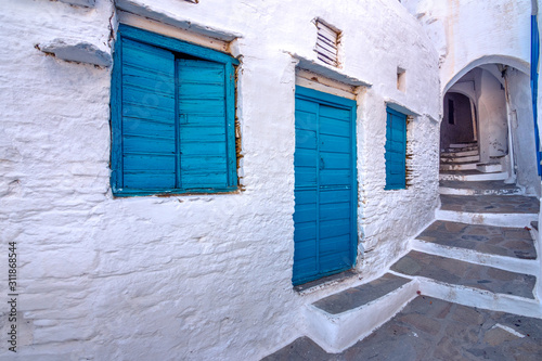 Fototapeta Naklejka Na Ścianę i Meble -  Narrow neighborhood streets and buildings at the old traditional village of Tripotamos, Tinos, Greece.