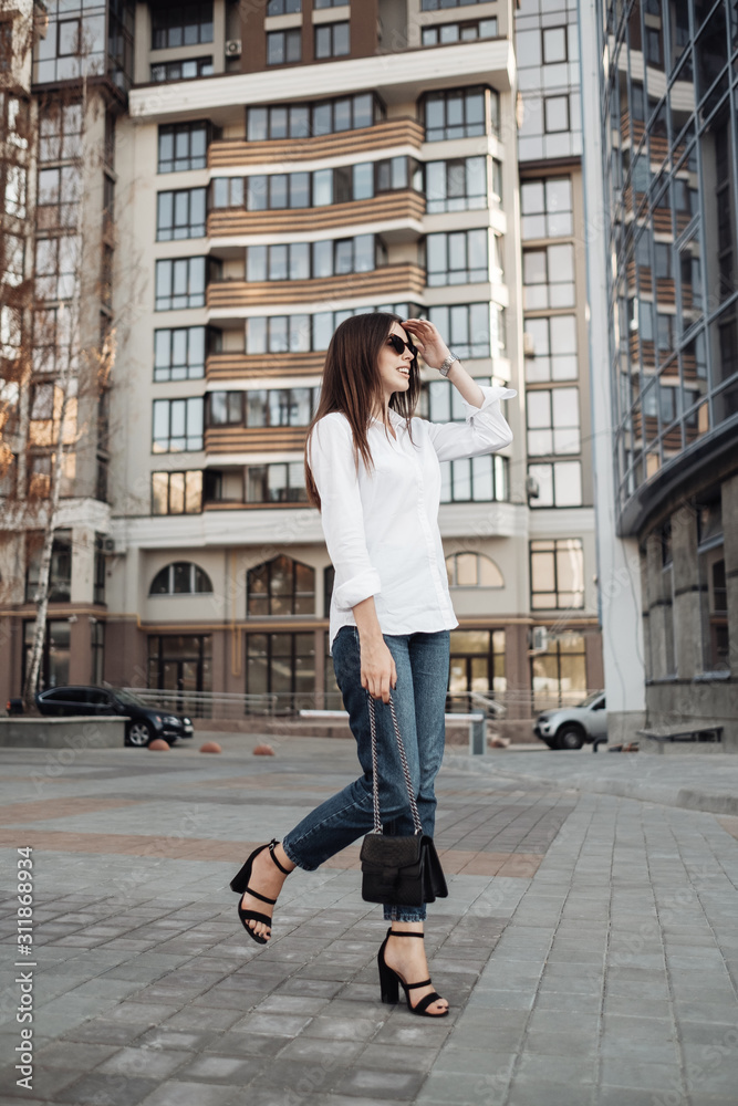 Portrait of One Fashionable Girl Dressed in Jeans and White Shirt, Business Lady, Woman Power Concept