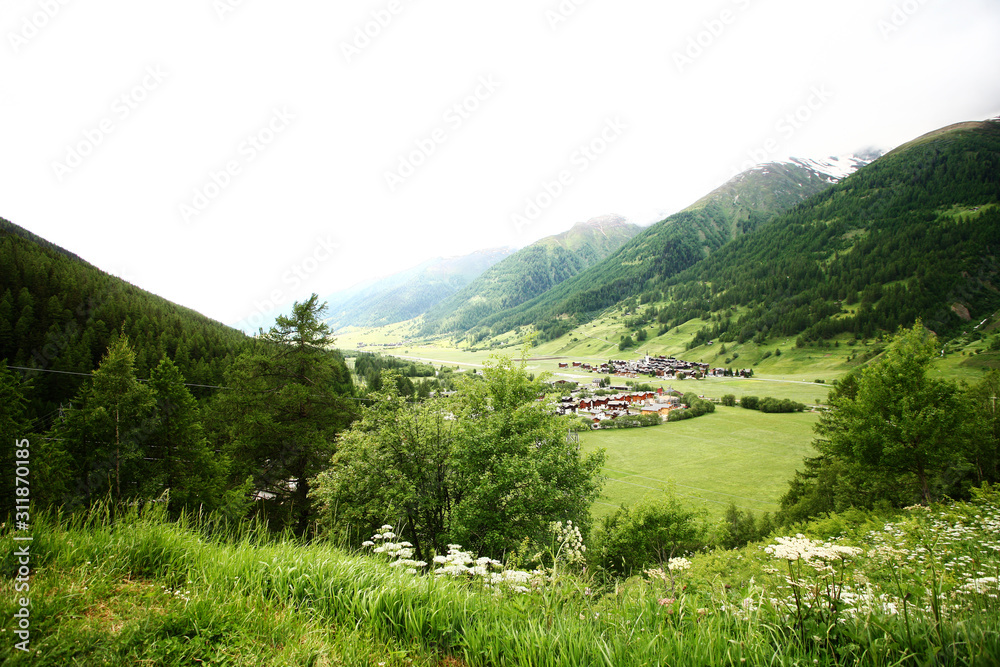 village in a Swiss valley with foggy weather