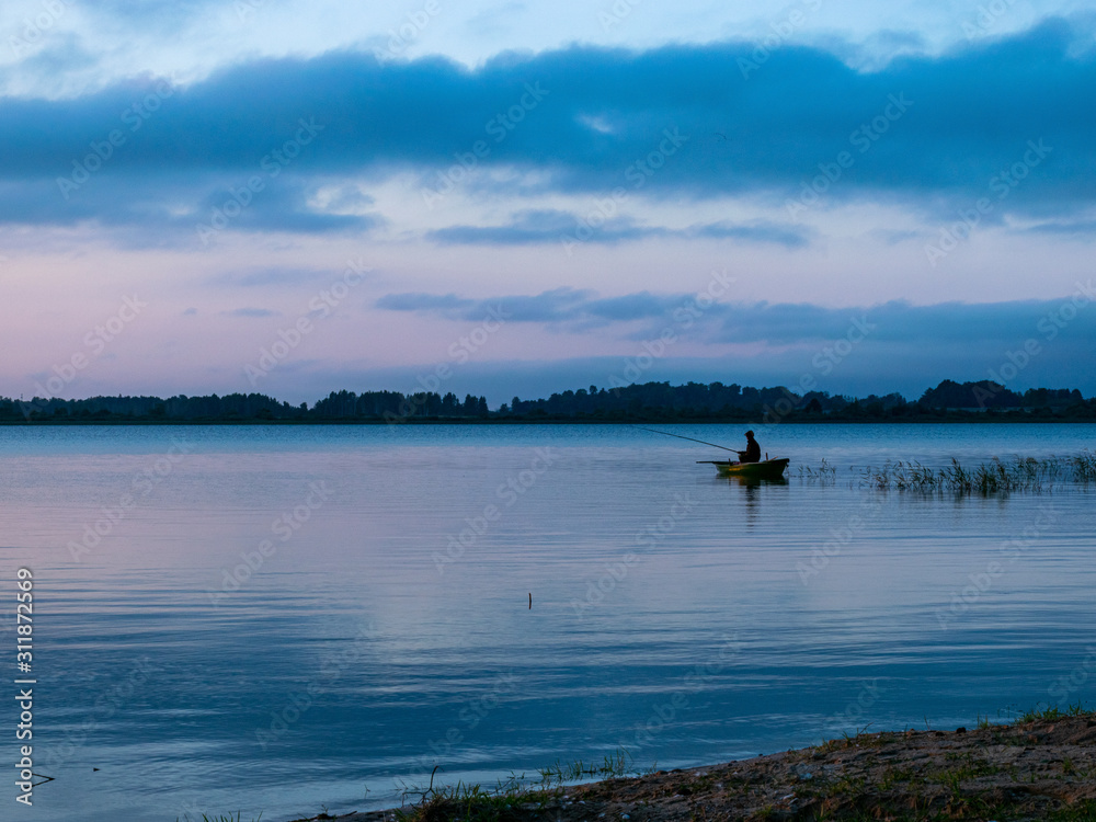 evening light on the lake, fisherman in boat, dusk