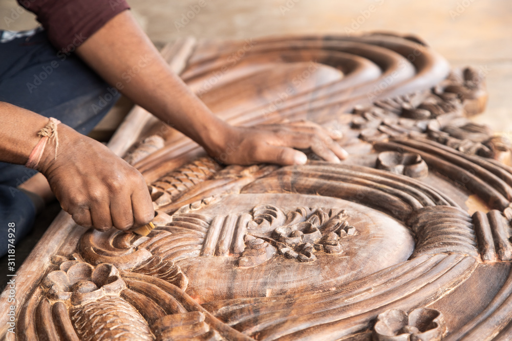 beautiful carved woodwork in an Indian street The hands of an