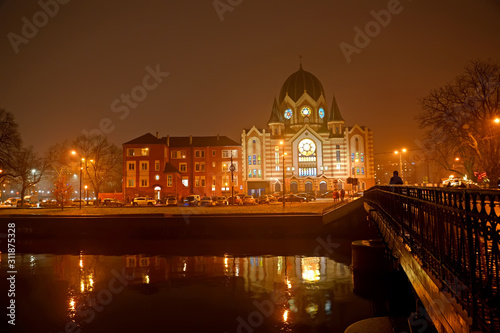 KALININGRAD, RUSSIA - DECEMBER 23, 2019:Evening view of the New Liberal Synagogue on the side of the Pregoli River photo