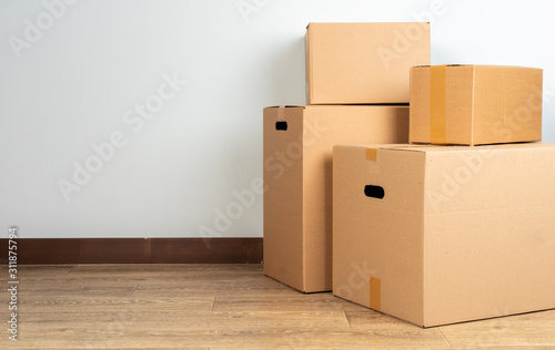 Group of brown carton boxes on wooden floor
