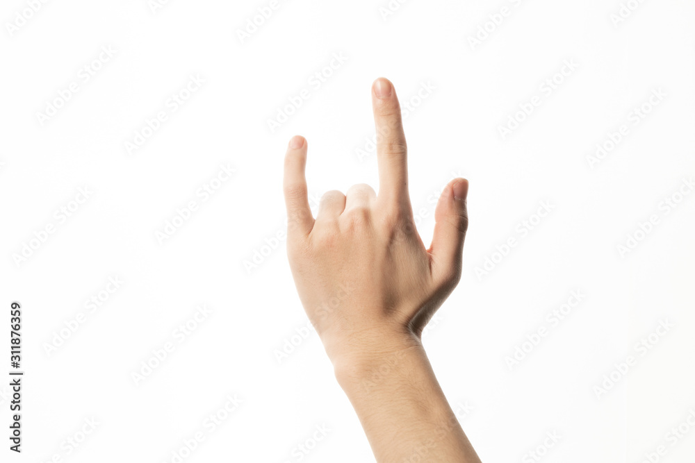 Male hand close-up on a white background shows hand gesture. Rock'n'roll. Isolate. Male hand close-up on a white background shows hand gesture. Rock'n'roll. Isolate.
