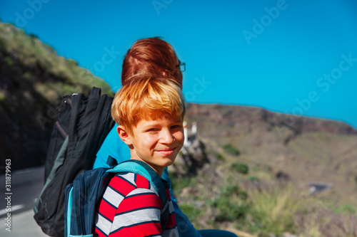 Bild auf Leinwand father and son travel on road in mountains