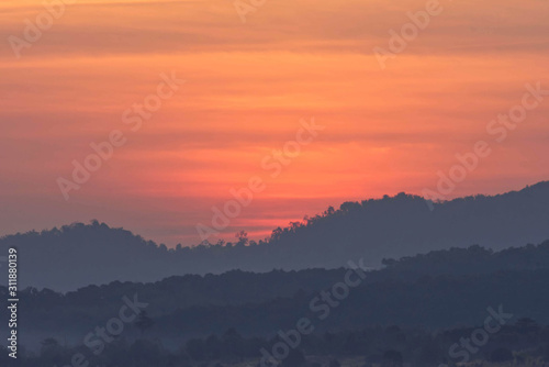 Sunrise and morning light behind the mountains with the mist covered at Khao Takhian Ngo Phetchabun in Thailand