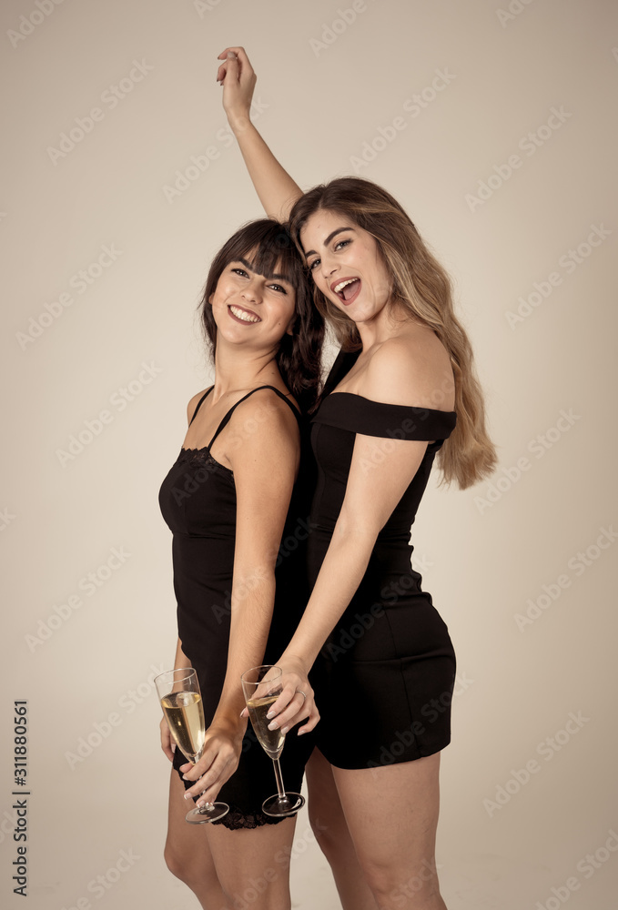 Portrait of two young attractive women with champagne glasses at celebration party Portrait of two young attractive women with champagne glasses at celebration party
