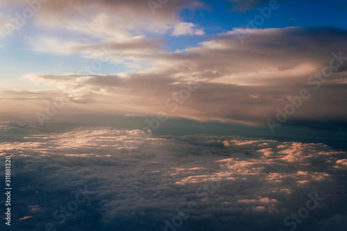 Sunset above the clouds landscape from an airplane journey