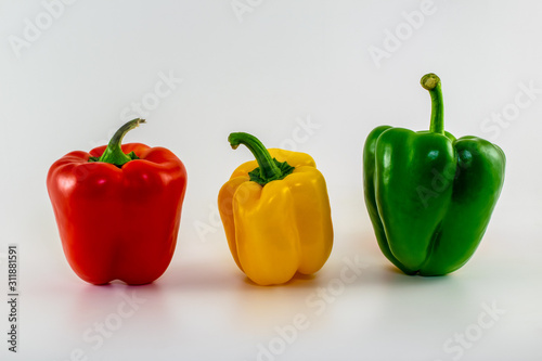 Three bell peppers with different colors. Red, yellow and green bell peppers isolated.