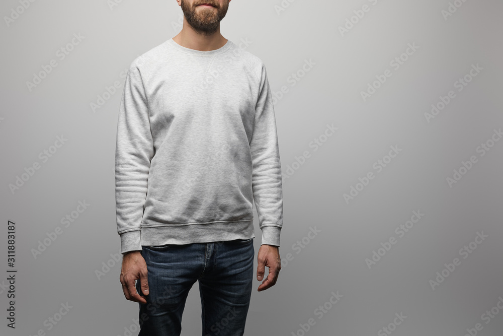 partial view of bearded man in blank basic grey sweatshirt isolated on grey partial view of bearded man in blank basic grey sweatshirt isolated on grey