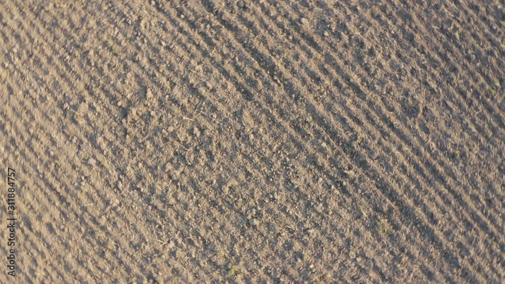 Aerial shot of plowed empty field during winter on sunny day - rotation top view - (filmed by an officially certified pilot) Aerial shot of plowed empty field during winter on sunny day - rotation top view - (filmed by an officially certified pilot)