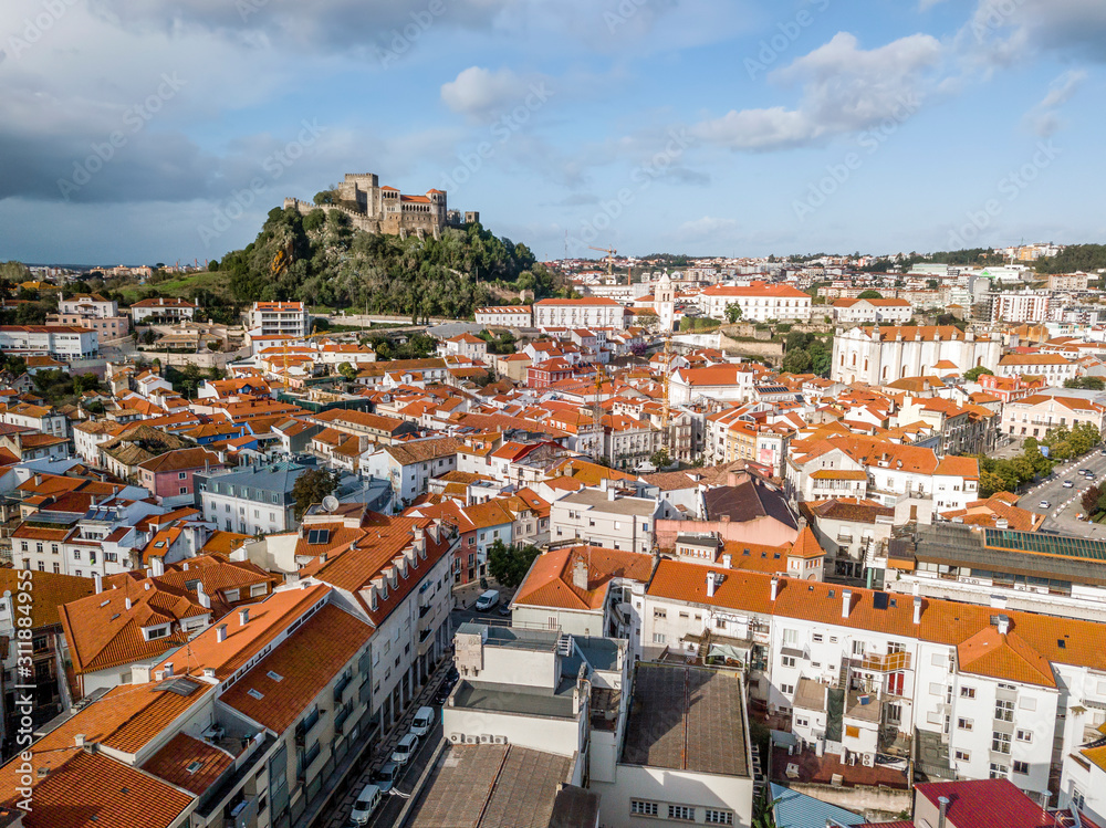 Aerial view of Leiria with red roofs and castle on the hill, Portugal