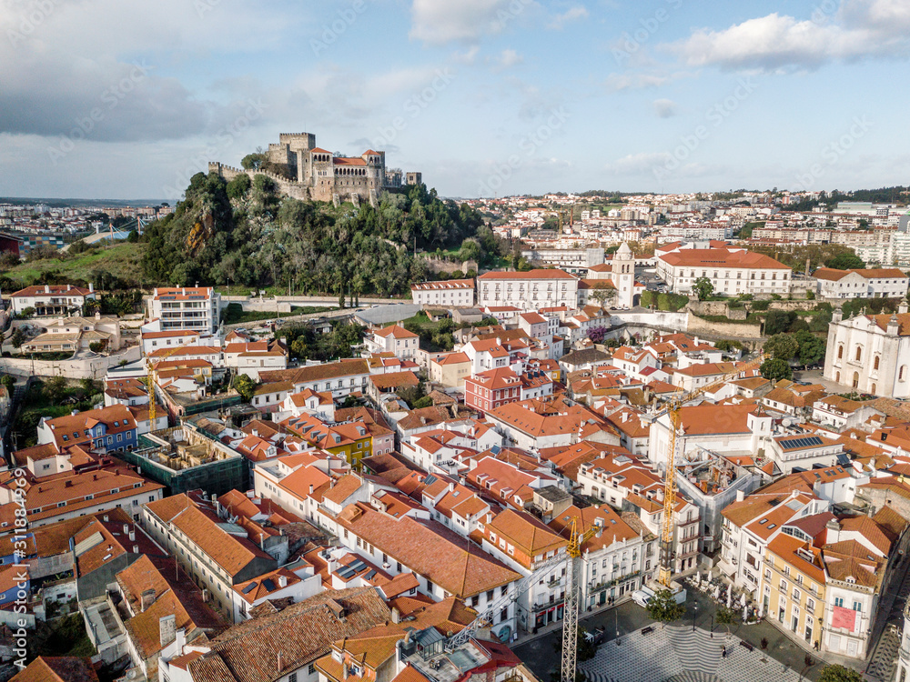 Aerial view of Leiria with red roofs and castle on the hill, Portugal