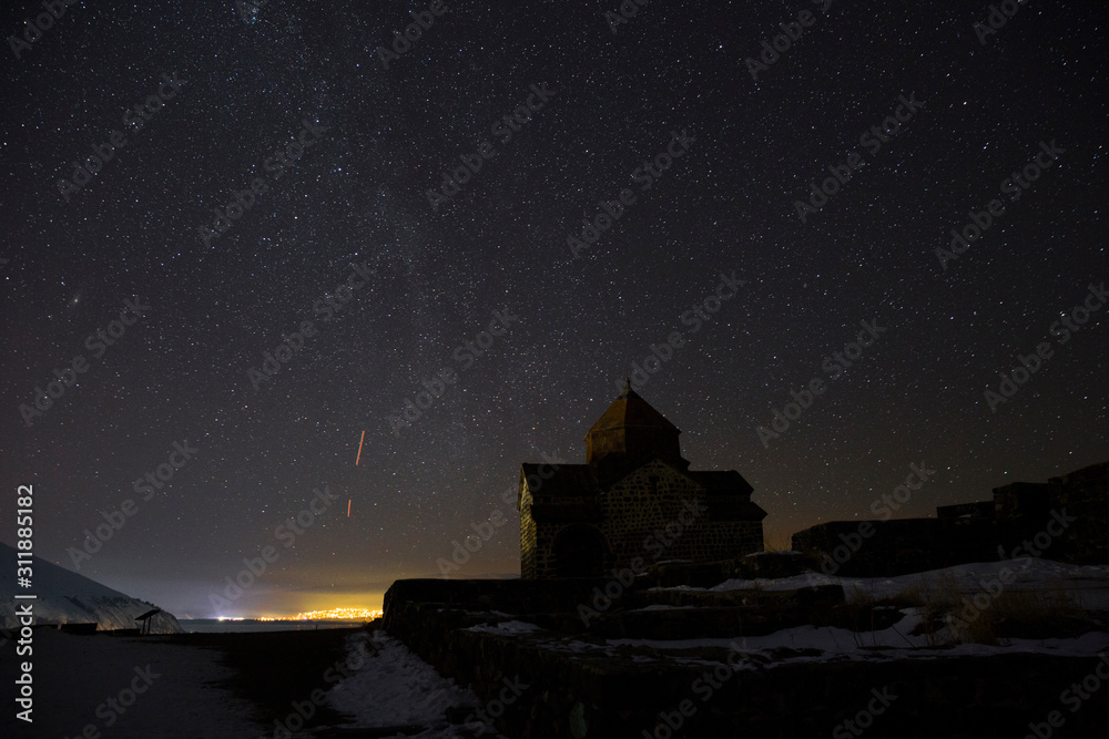 Sevanavank on the background of the night starry sky. Sevanavank is a monastic complex located on a peninsula at the northwestern shore of Lake Sevan Sevanavank on the background of the night starry sky. Sevanavank is a monastic complex located on a peninsula at the northwestern shore of Lake Sevan
