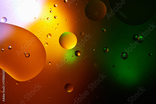 Beautiful abstract background from mixed water and oil in orange and green