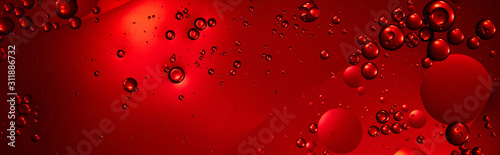 panoramic shot of creative red color background from mixed water and oil bubbles