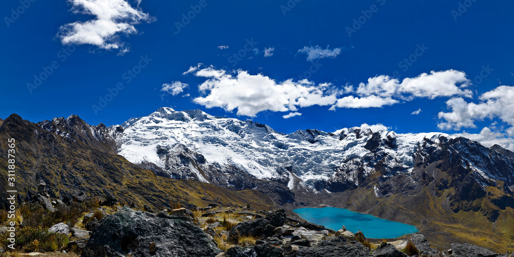 Panorama of Sunset view of the snowy Huaytapallana next to lagoons in the central mountain range of the Peruvian Andes