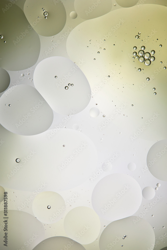 texture from mixed water and oil bubbles in light green and grey