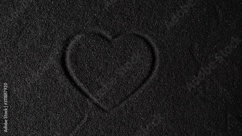  Black sand background with heart drawing on sand