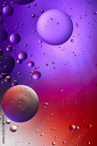 abstract creative purple and red color background from mixed water and oil bubbles