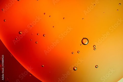 Beautiful abstract background from mixed water and oil in orange color