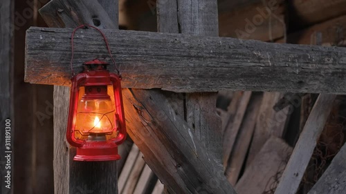 Close up of red  kerosene lamp on the wooden wall