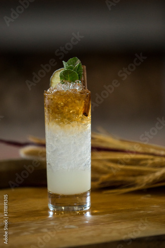 Alcohol cocktail on a wooden barrel