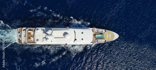 Aerial drone ultra wide photo of luxury mega yacht with wooden deck cruising Aegean deep blue sea © aerial-drone