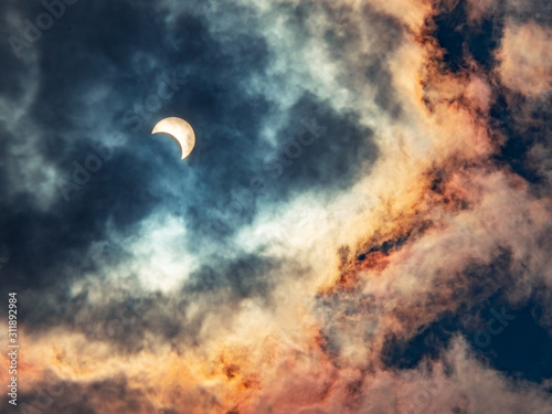 Solar eclipses caused by the shadow of the moon covering the sun In the midst of thick clouds, the end of the year 2019 © iOkay